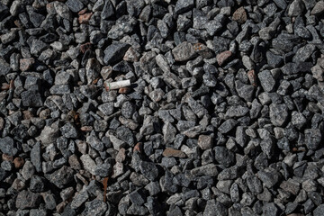 cigarette butt alone on the gravel floor