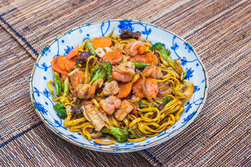 Oriental food yakissoba in wood floor.