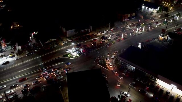 Aerial view of Hidalgo Avenue crossroad with fanatics celebrating the championship of their soccer team in Tampico at night creating traffic jam