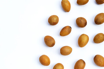 Obraz premium Fresh half sapodilla fruit and whole isolated on white background.