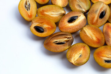 Fresh half sapodilla fruit isolated on white