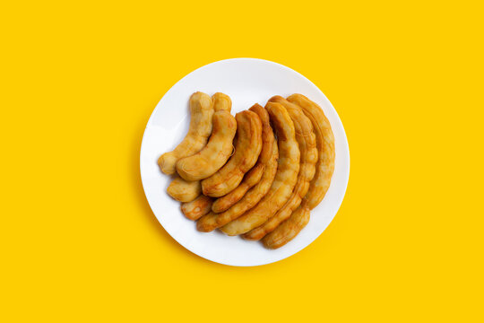 Tamarind pickled fermented on yellow background.