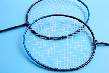 Badminton rackets on blue background.