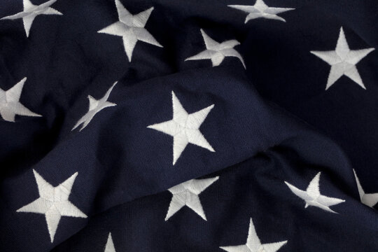 Single center star in focus with other stars on blue section of American Flag