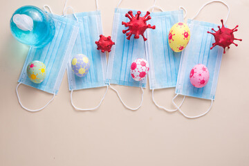 Happy Easter day eggs and Coronavirus (COVID-19) has surgical masks alcohol gel on paper background with copy space