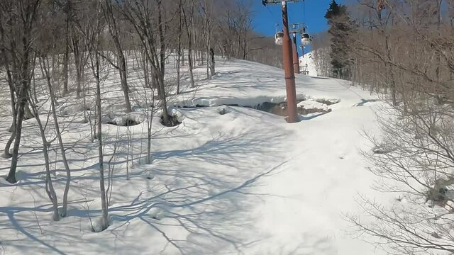 View of the snowy mountain gondola. Uphill