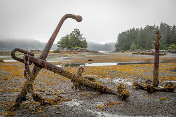 USA, Alaska, Sitka. Old anchors at ocean low tide.
