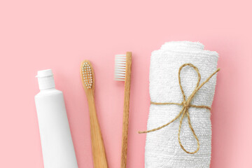 Set of eco-friendly toothbrushes, toothpaste and other tools on pink background. Dental and healthcare concept. Top view, flat lay.