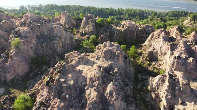Aerial view deforest condition of yellow rugged stone hill in sunny day