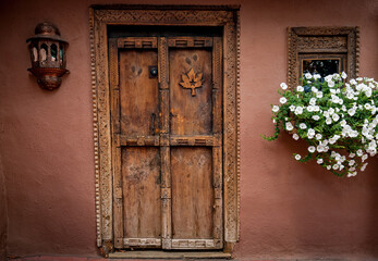 Naklejka premium Decorative door of carved wood in Santa Fe, New Mexico.CR2