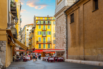 A lively afternoon at the Place Rossetti as tourists enjoy the cafes and shops in the colorful Vieux Old Town of Nice, France on the French Riviera.