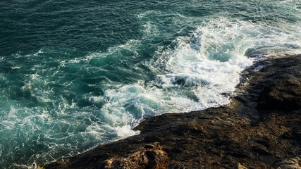 Green sea waves with rocks.