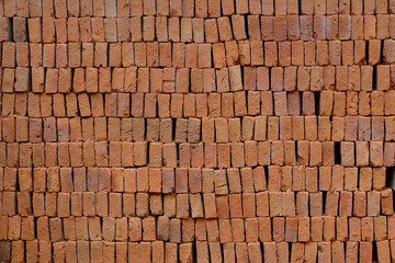 A pile of orange clay bricks.