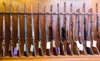 Gun store interior with specialized rifles on showcase