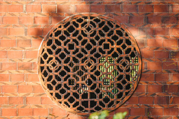 Chinese traditional red brick wall with old stone carving