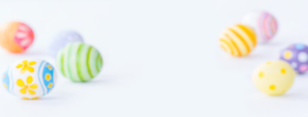 blurred colorful eggs on white background with copy space for Happy Easter day