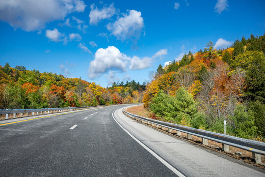 Fabulous highway with scenic autumn maple trees along the road in Vermont