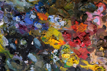 Naklejka na ściany i meble Background of an artist's palette with mixed dried acrylic paints. An abstract artwork. 