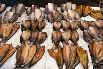 Sun dried trichogaster pectoralis fish on flat bamboo basket, Trichogaster pectoralis in fresh market. Dried trichogaster pectoralis fish on bamboo basket in Thailand market, traditional food concept
