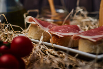 local products Still life of Serrano ham with tomatoes and olive oil