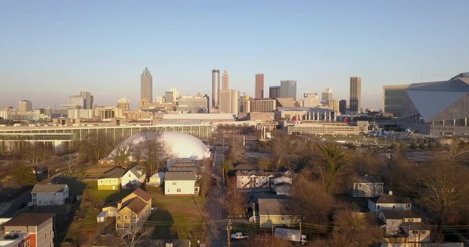 Aerial view of downtown Atlanta, Georgia and Westside suburban neighborhoods in the metro downtown area. Drone shot in sunset featuring a gorgeous skyline and GWCC of Atlanta, Georgia USA.