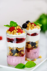 Berry dessert with mousse, granola and fresh berries.