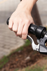 Obraz premium Man's hand using brake on electric bike