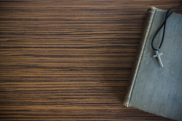 Christian cross with Bible on a wooden tabel