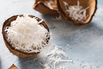 Fototapeta na wymiar Coconut with flakes on color background
