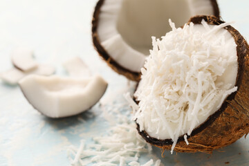 Coconut with flakes on light background