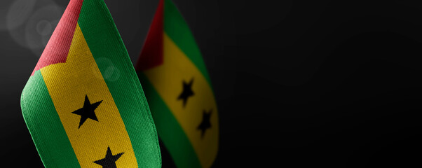 Small national flags of the Sao Tome and Principe on a dark background