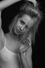 black-and-white portrait of a blonde on a black background.