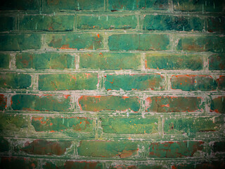The texture of a brick wall painted in green. Brick wall. Green paint. Background image. Place for...