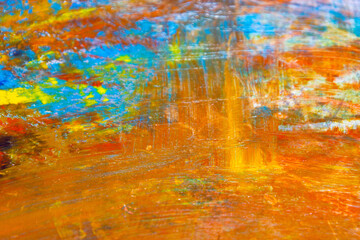 colorful creative motley background: smudged residues of oil paints on a wooden palette, short focus, selective blur