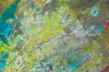 colorful creative motley background: smudged residues of oil paints on a wooden palette, short focus, selective blur