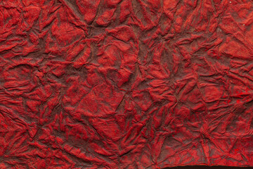 A beautiful red color handmade paper of crumple or wrinkle texture with veins and fibers. Useful for background, 3d rendering.