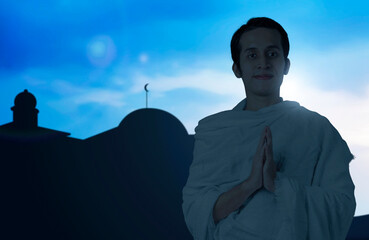 Asian Muslim man in ihram clothes standing with greeting gesture