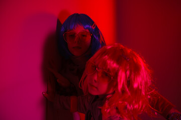 Little girls wearing a colorful wigs posed for a photo shooting