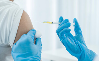 Female doctors vaccinated with syringes to prevent epidemics at hospitals, health care, and medical...