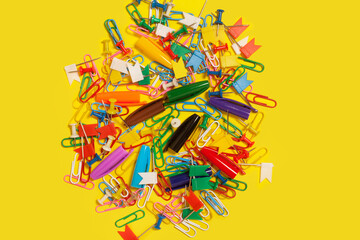 pile of paper clips, pushpins and pen caps