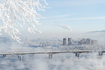 winter in the city Krasnoyarsk bridge snow frost smog