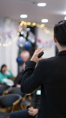 Presenter at corporate conference giving speech. Speaker giving lecture to business audience in...