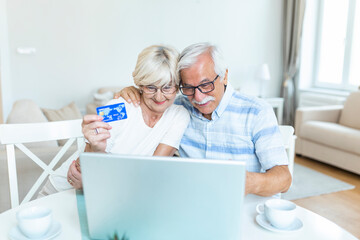 Senior Couple Using Laptop To Shop Online. Elderly couple paying bills online on laptop. Excited senior woman showing smiling middle aged husband online shopping sale on web site
