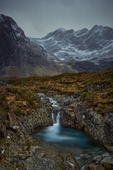 Fototapeta na wymiar mountainous valley with river, waterfall and lake. concept of nature, freedom, tourism, trekking - Fairy Pools - Skye Island - Scotland - Uk