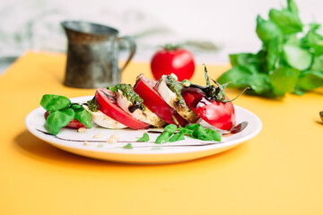Caprese salad. Tomatoes, mozzarella, basil, pesto, balsamic sauce