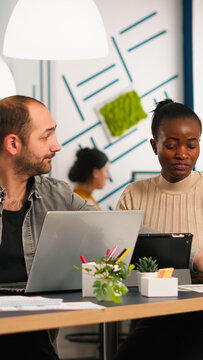 Team of diverse startup company colleague entrepreneur meeting in professional workplace, brifing and sharing ideas over financial strategy management. Multiracial business people working together.