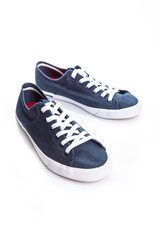 blue sneakers on white background with copy space. Youth shoes.