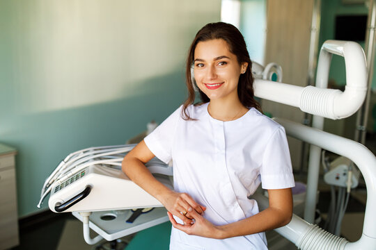Image of a beautiful happy young woman doctor in medical dentist center.