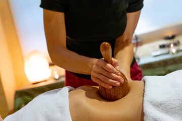 Masseuse giving a wood massage therapy massage to a client