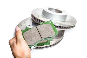 brake pad in hand on background Perforated improved brake discs isolated on white background